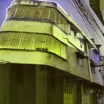 Three-story building on a narrow street.