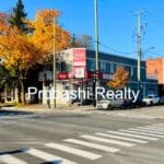Street intersection with autumn trees and buildings.