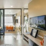 Modern living room with dining area and TV.