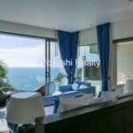Modern bedroom with ocean view and balcony.
