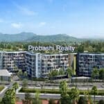 Modern residential complex with mountain backdrop.