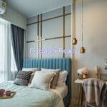 Modern bedroom with stylish decor and lighting.