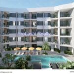 Modern apartment building with swimming pool.