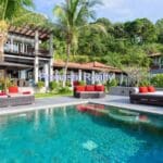 Luxury villa with pool and palm trees.