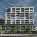 Modern apartment building with blue sky background.