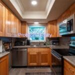 Modern kitchen with wooden cabinets and appliances.