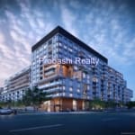 Modern apartment building under cloudy sky.