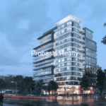 Modern glass building on rainy evening street.