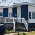 Blue and white suburban house with stairs.