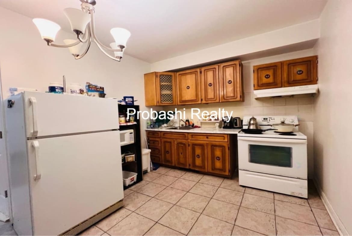 Cozy kitchen with wooden cabinets and white appliances.