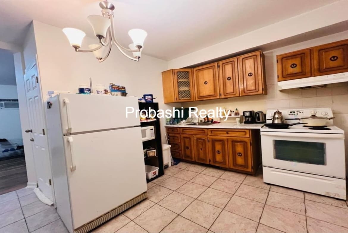 Cozy kitchen with wooden cabinets and modern appliances.